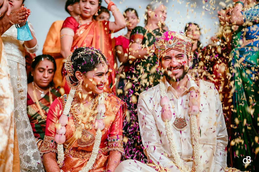 throwing flower petals toward bride and groom and best wedding moment capture dinesh boiri team